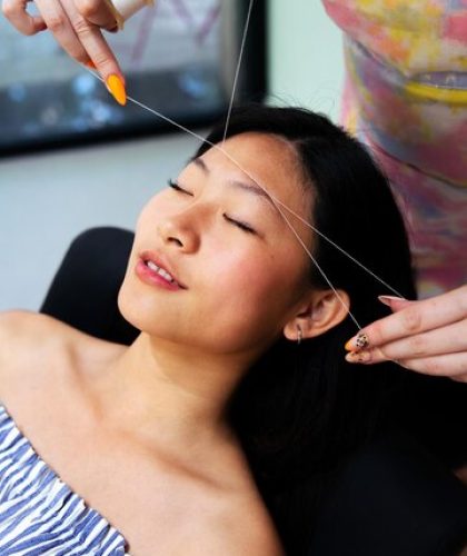 beautician-performs-eyebrow-threading-woman_362480-1935