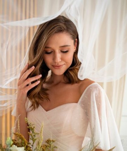 beautiful-bride-holding-flowers-medium-shot_23-2149640963