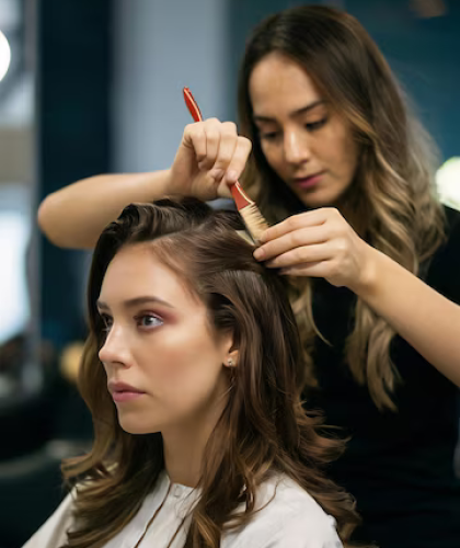 close-up-hrdresser-is-dying-hr-client-with-brush-while-working-professional-salon_1336671-52465