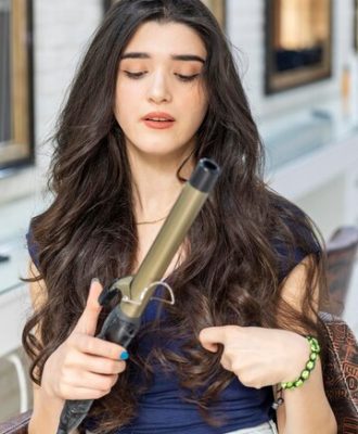 thoughtful-young-woman-holding-hair-dryer-looking-it-high-quality-photo_144627-75998