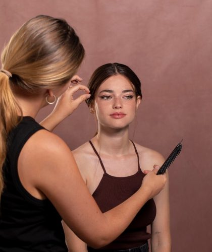 young-female-model-having-her-make-up-done-by-professional-artist_23-2149084946